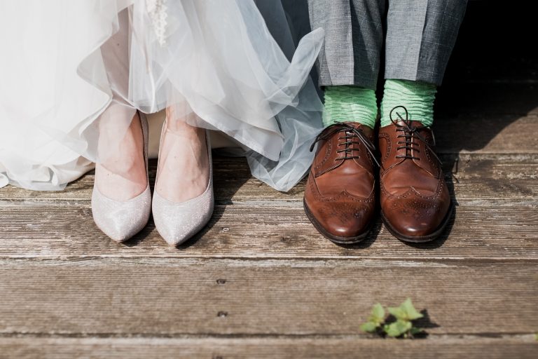 two people standing on brown wooden floor