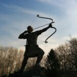 man holding archer statue