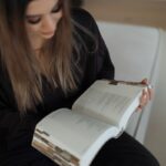 A woman reading a large open book