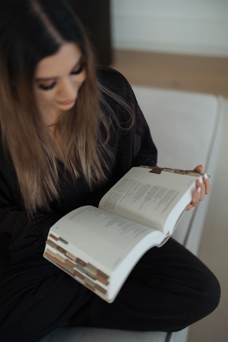 A woman reading a large open book