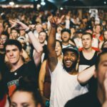 excited crowd cheering at concert or event